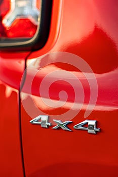 Grunge track 4x4 letters. The designation of all-wheel drive on SUVs. Unique off-road inscription in silver on a red back