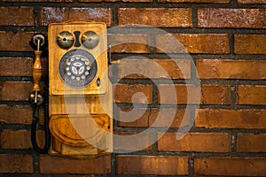 Grunge urban background of a brick wall with an old out of service payphone