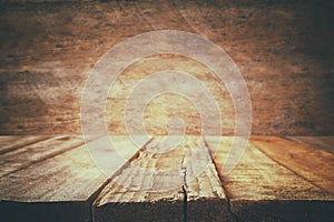 Grunge wooden board table in front of old wooden background