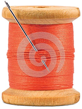 Grunge wooden bobbin with red thread isolated photo