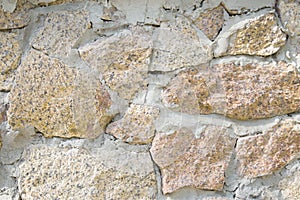 Grunge yellow stonework, masonry wall texture or background. Closeup