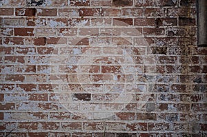 Grungy brown brick texture with pealing paint