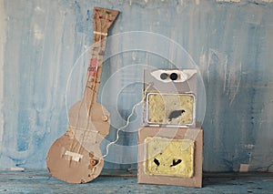 Grungy cardboard model of a guitar and an amp stack,music, live performance,grunge rock concept