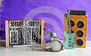 Grungy cardboard models of synthesizer,drum kit,guitar,amplifier on stage,music,performance,instruments concept,free copy space
