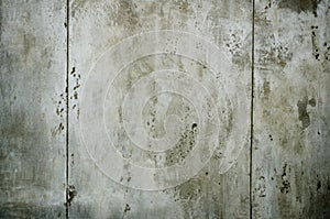 Grungy concrete gray wall with dark spots, surface is similar to moon surface, background for photo wallpaper