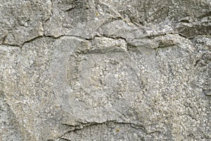 Grungy cracked stone texture from natural rock retro style. Weathered ancient wall background