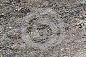 Grungy cracked stone texture from natural rock retro style. Weathered ancient wall background