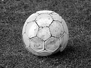 Grungy football on the grass monochrome