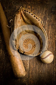 Grungy old baseball gloves and ball