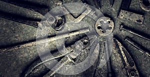 Grungy old metalwork tools on stained table background