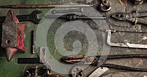 Grungy old metalwork tools on stained table background