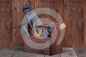 Grungy old tools on a wooden background