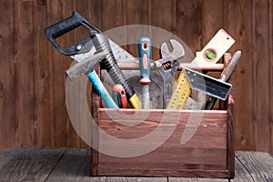 Grungy old tools on a wooden background