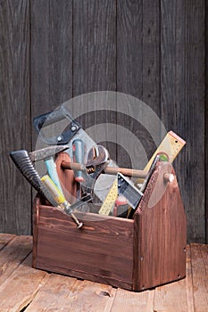 Grungy old tools on a wooden background