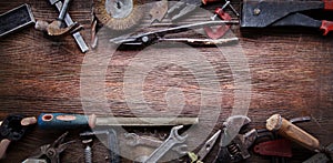 Grungy old tools on a wooden background