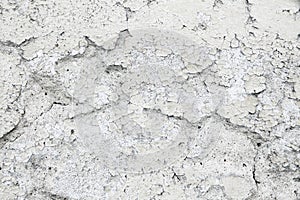 Grungy and old weathered white wall stucco plaster texture background marked by long exposure to the elements outdoors photo