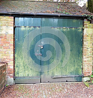 Grungy old wooden outhouse double doors