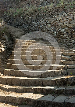 A grungy stone staircase up a hill