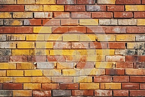 Grungy yellow and red brick wall as a seamless pattern background.