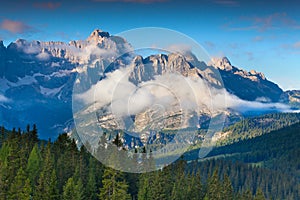 Gruppo Del Cristallo mountain range at foggy summer morning. Dolomites mountains, Italy, Europe.