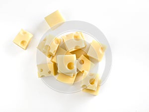 Gruyere cheese cubes seen from above on a white table photo