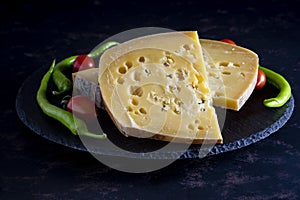Gruyere cheese on dark background.