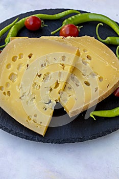 Gruyere cheese on wood background. Story format