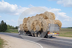 Gruzovik- Gauges loaded with round bales of straw rides on the highway