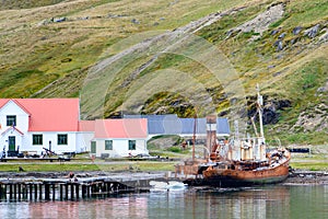 Grytviken shipwrecks of abandoned whaling station in South Georgia. Lost places with rusty tanks, old boats, Antarctica.