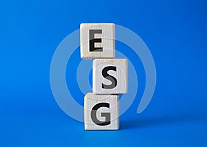 GSG - Environmental, Social and Governance symbol. Concept word GSG on wooden cubes. Beautiful blue background. Business and GSG