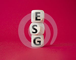 GSG - Environmental, Social and Governance symbol. Concept word GSG on wooden cubes. Beautiful red background. Business and GSG