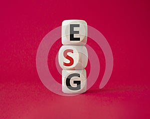 GSG - Environmental, Social and Governance symbol. Concept word GSG on wooden cubes. Beautiful red background. Business and GSG