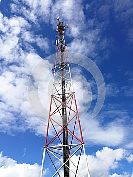 GSM repeater tower in front of blue cloudy sky