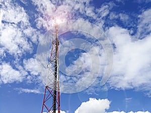 GSM repeater tower in front of blue cloudy sky