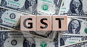 GST, goods and services tax symbol. Concept words GST, goods and services tax on wooden cubes on a beautiful background from