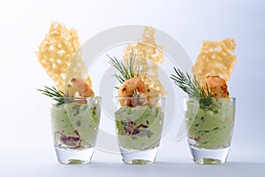 Guacamole avocado cream with tiger shrimps or prawns and crisp c