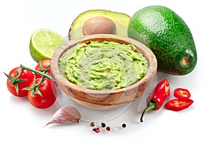 Guacamole bowl and guacamole ingredients isolated on white background