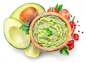 Guacamole bowl and guacamole ingredients isolated on white background. Flat lay