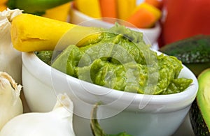 Guacamole Dip Closeup Surrounded by colorful vegetables and ingredients