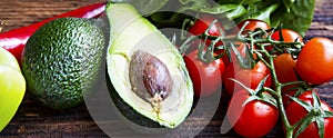 Guacamole ingredients.Avocado half with cherry tomatoes