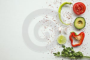 Guacamole ingredients on white background: avocado, paprika, tomato, onion