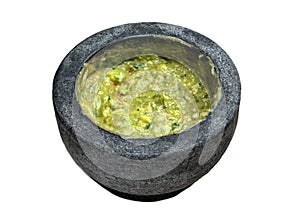 guacamole inside molcajete (traditional mexican mortar and pestle for grinding spices) avocado dip white background