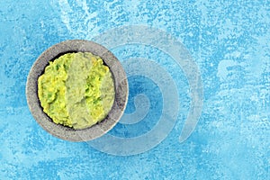 Guacamole in a molcajete, Mexican avocado dip in the typical stone mortar