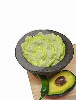 Guacamole in a molcajete, traditional Mexican of stone mortar. avocado and chili