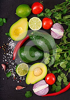 Guacamole sauce ingredients - avocado, tomato, onion, pepper chili, garlic, cilantro, lime