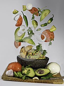 Guacamoles with the ingredients flying photo