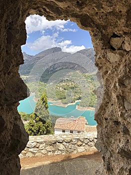 Guadalest Reservoir looking through a rocky arch, Spain