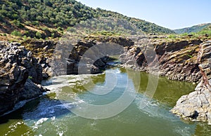 Guadiana river flows through the deep gully in schists. Pulo do