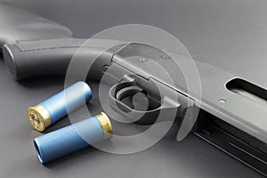 A 12 guage Shotgun with Blue shotgun shells photo