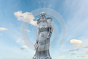 Guan Yin statue stone god of china on sky background.